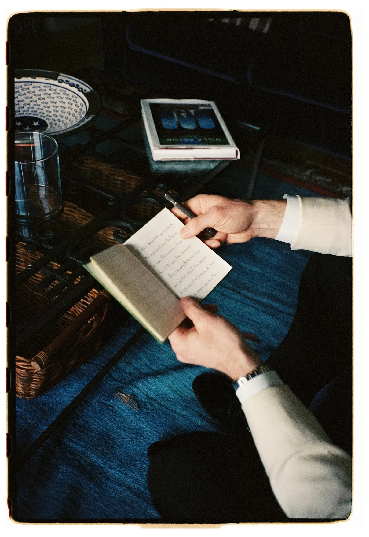 Groom reading handwritten vows alone before the ceremony
