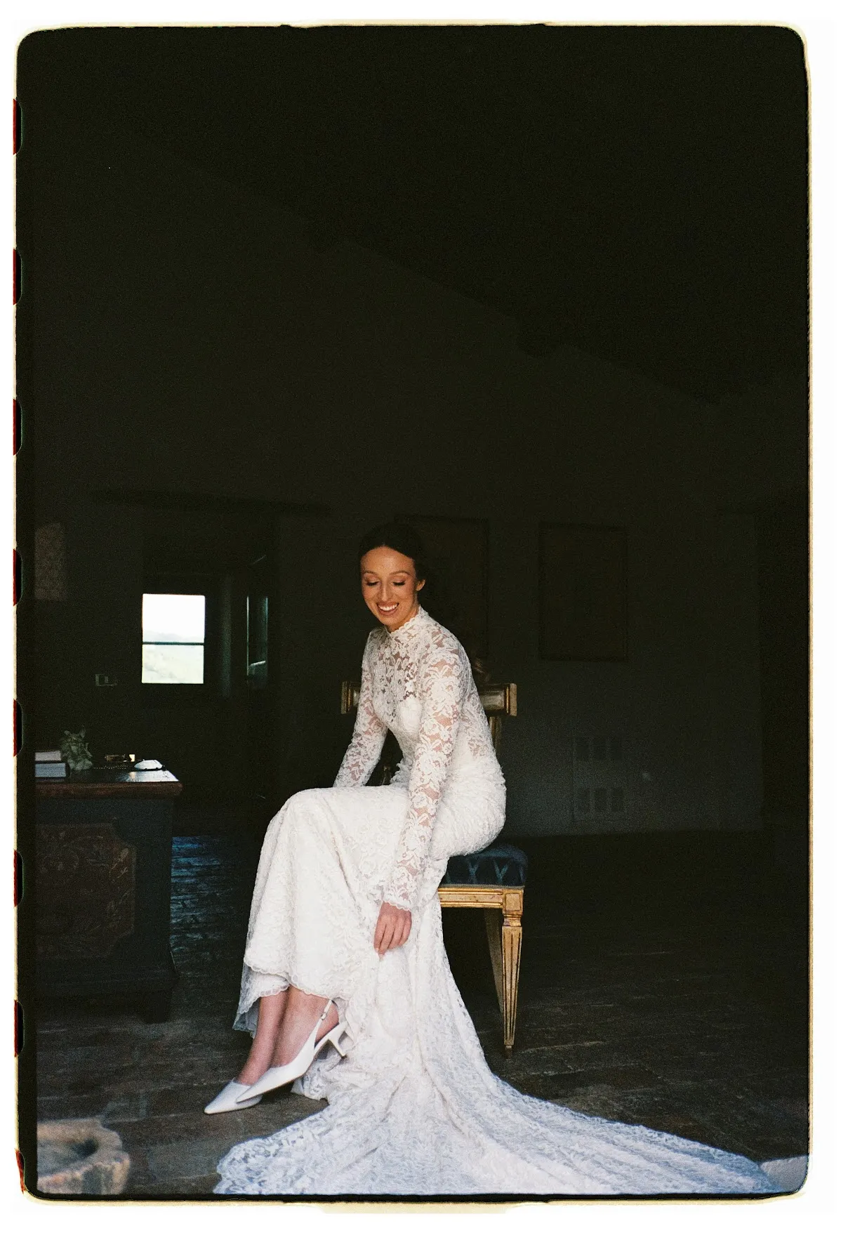 Bride in high-neck lace gown holding white calla lily bouquet